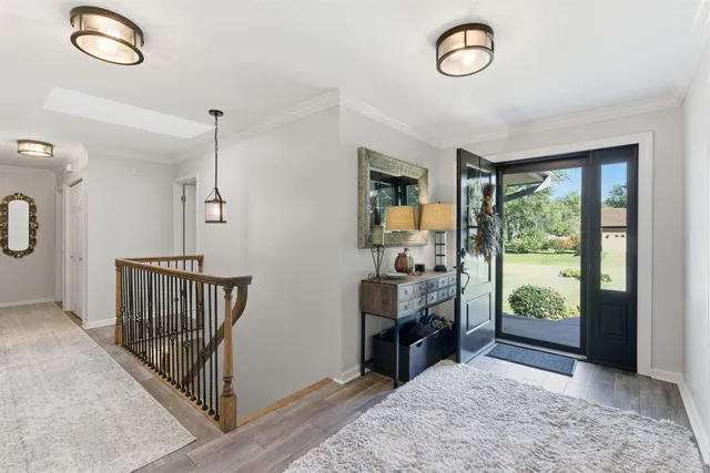 a view of a hallway with workspace and windows
