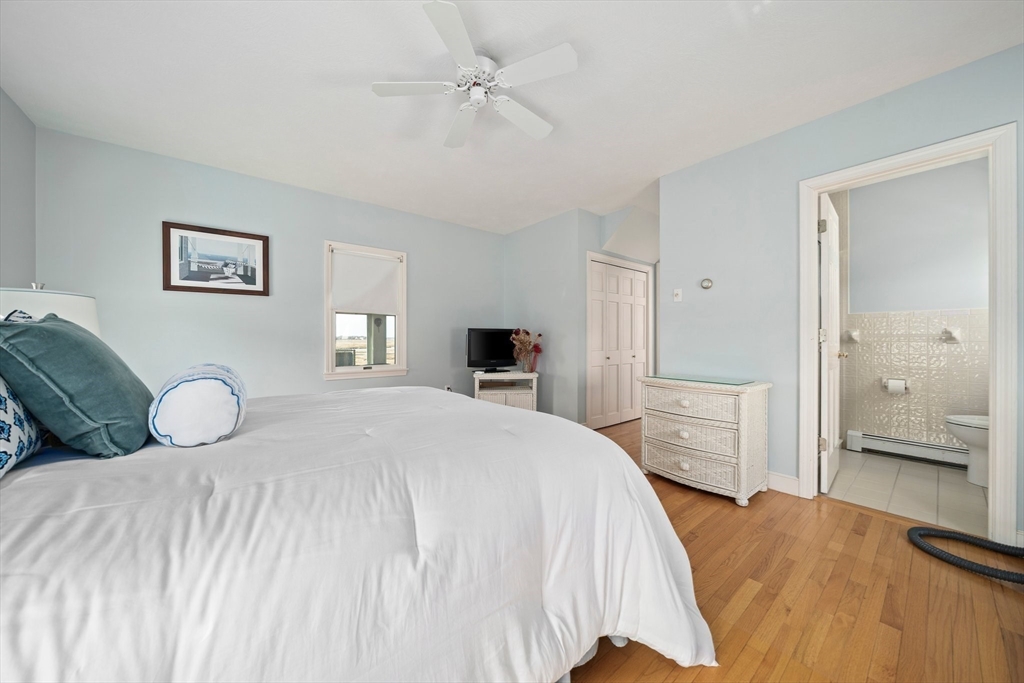 97 Central Avenue Scituate, MA 02050 - Photo 15 of 41 a bedroom with a bed and a chandelier
