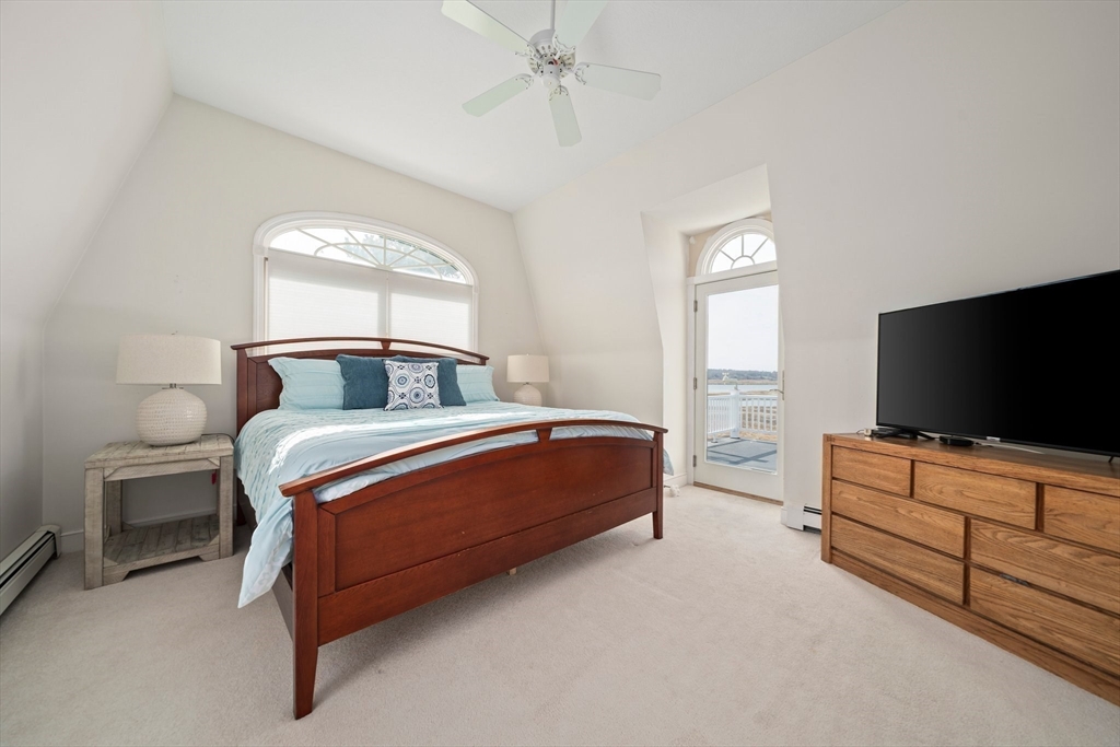 97 Central Avenue Scituate, MA 02050 - Photo 18 of 41 a bedroom with a bed and a flat tv screen on wall