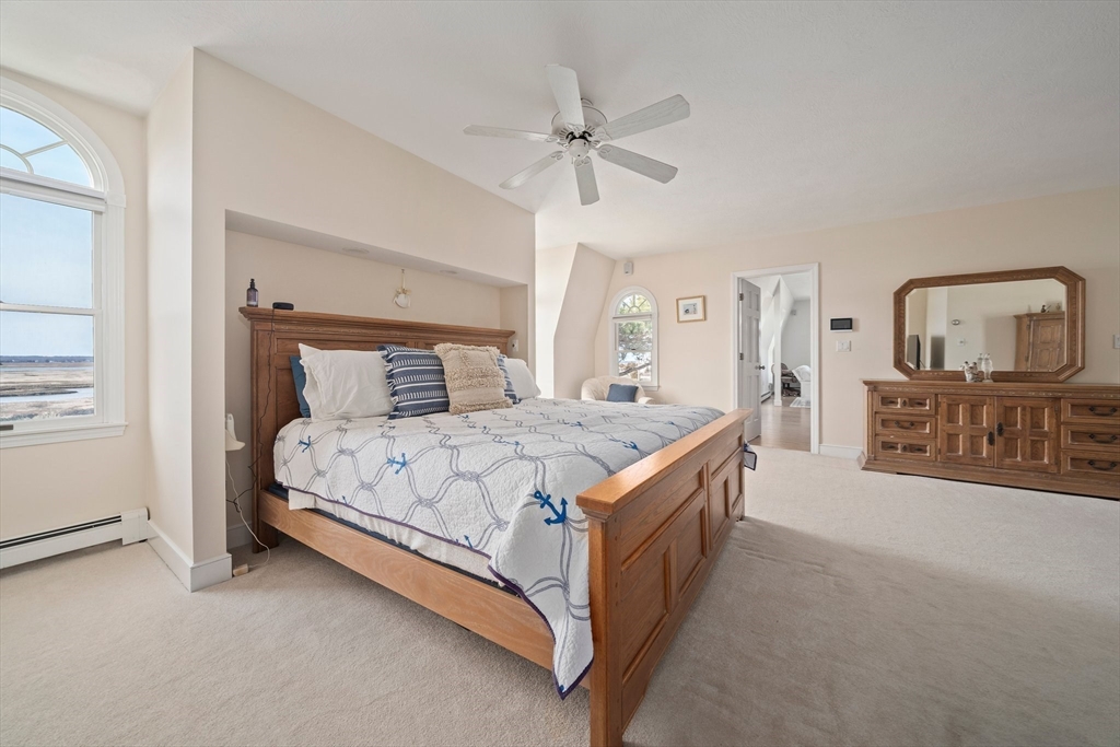97 Central Avenue Scituate, MA 02050 - Photo 23 of 41 a bedroom with a large bed and a chandelier