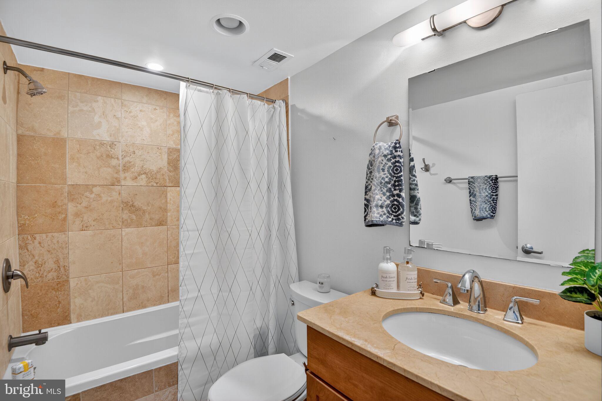 1323 K Street Southeast, Unit 203 Washington, DC 20003 - Photo 11 of 25 Travertine tiled bathroom