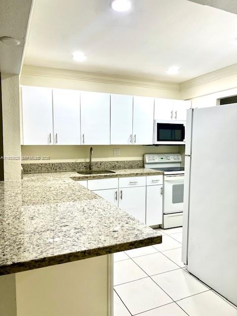 7900 South Colony Circle, Unit 105 Tamarac, FL 33321 - Photo 6 of 13 a kitchen with stainless steel appliances granite countertop a sink and a stove