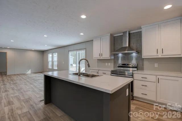 a kitchen with stainless steel appliances a sink stove and cabinets