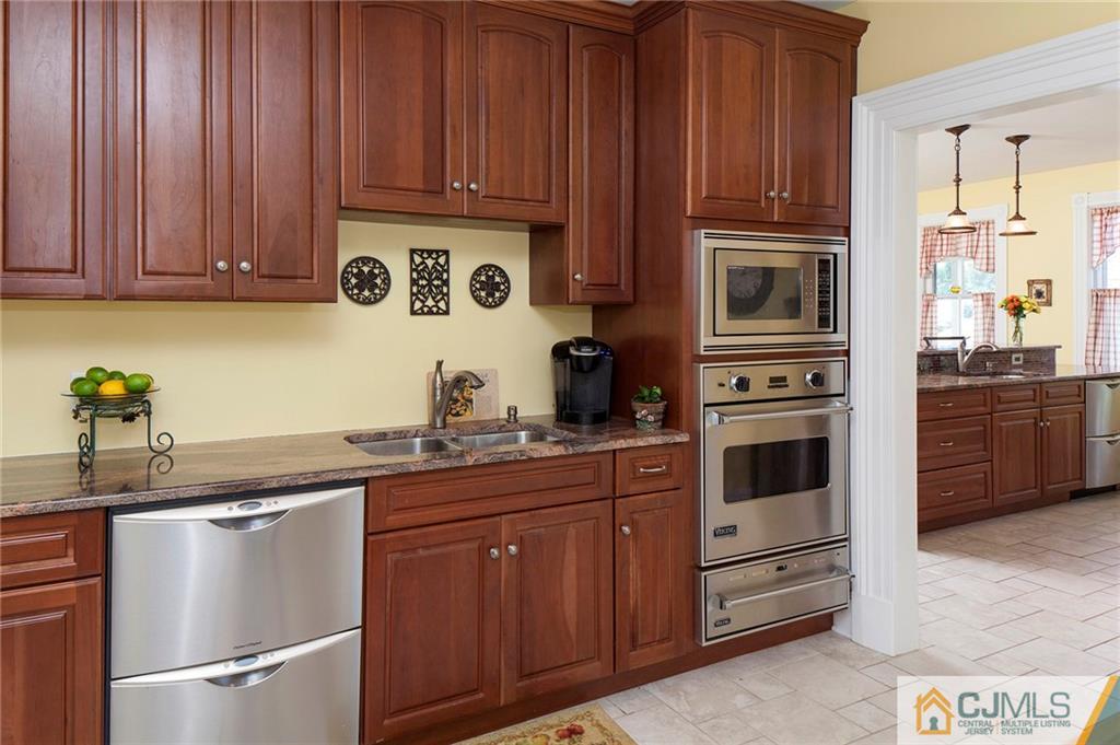 136 Mapleton Road Princeton, NJ 08540 - Photo 11 of 25 a kitchen with granite countertop wooden cabinets and white appliances