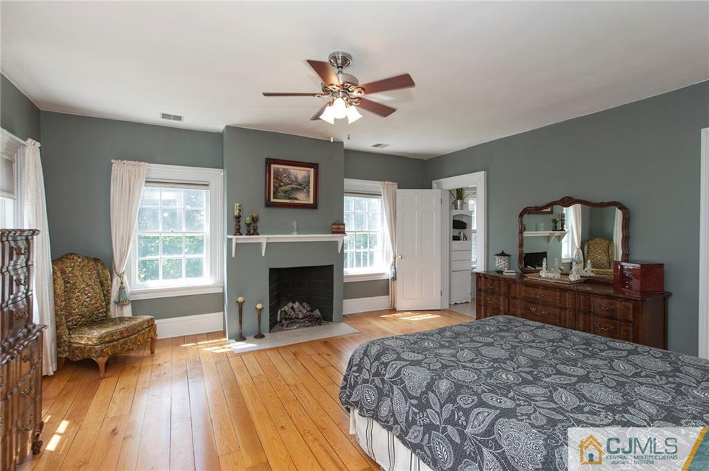 136 Mapleton Road Princeton, NJ 08540 - Photo 16 of 25 a bedroom with a bed and a fireplace