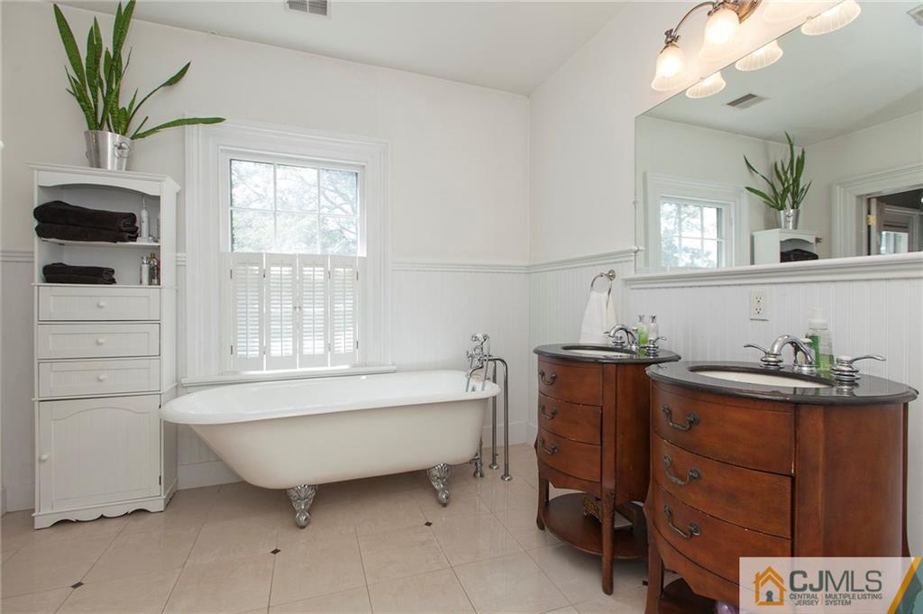 136 Mapleton Road Princeton, NJ 08540 - Photo 17 of 25 a bathroom with a bathtub sink and mirror