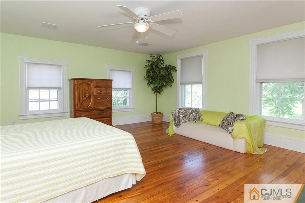 136 Mapleton Road Princeton, NJ 08540 - Photo 19 of 25 a spacious bedroom with a bed and a couch