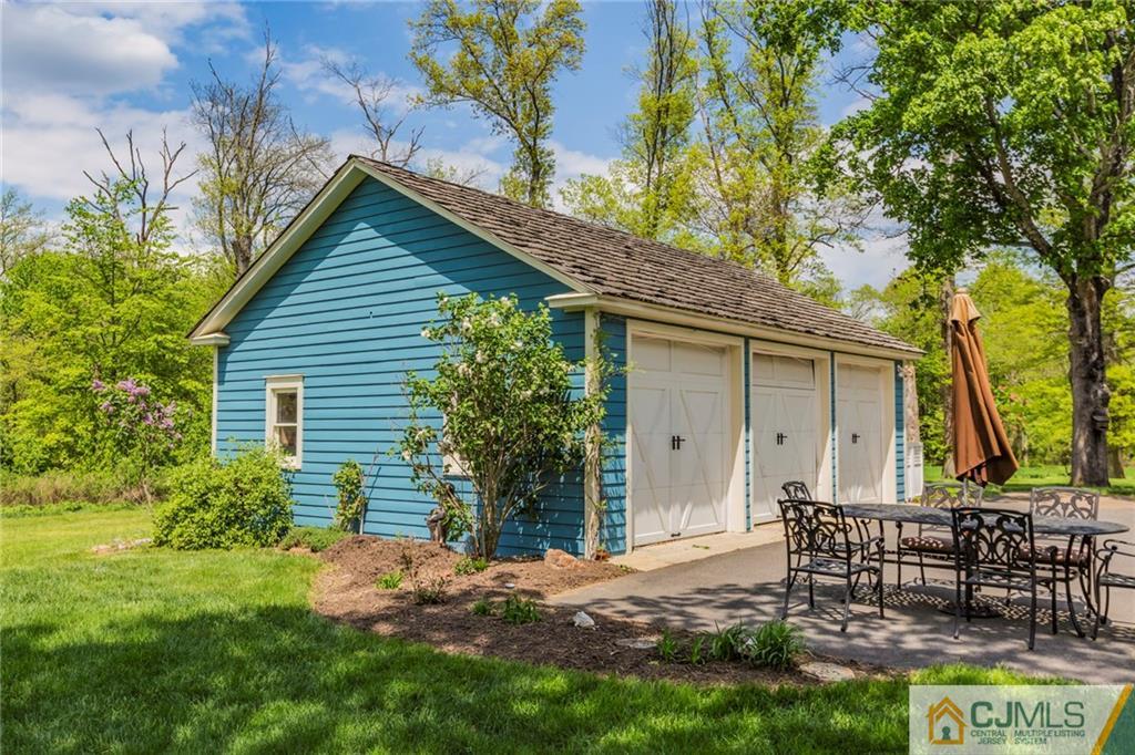 136 Mapleton Road Princeton, NJ 08540 - Photo 24 of 25 a backyard of a house with plants and tree