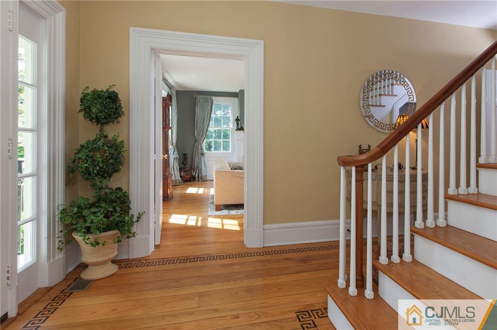 136 Mapleton Road Princeton, NJ 08540 - Photo 5 of 25 a view of a hallway with wooden floor and stairs