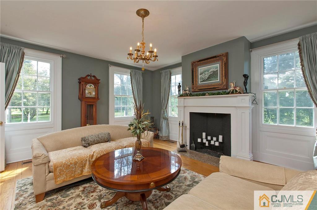 136 Mapleton Road Princeton, NJ 08540 - Photo 6 of 25 a living room with furniture a chandelier and a fireplace