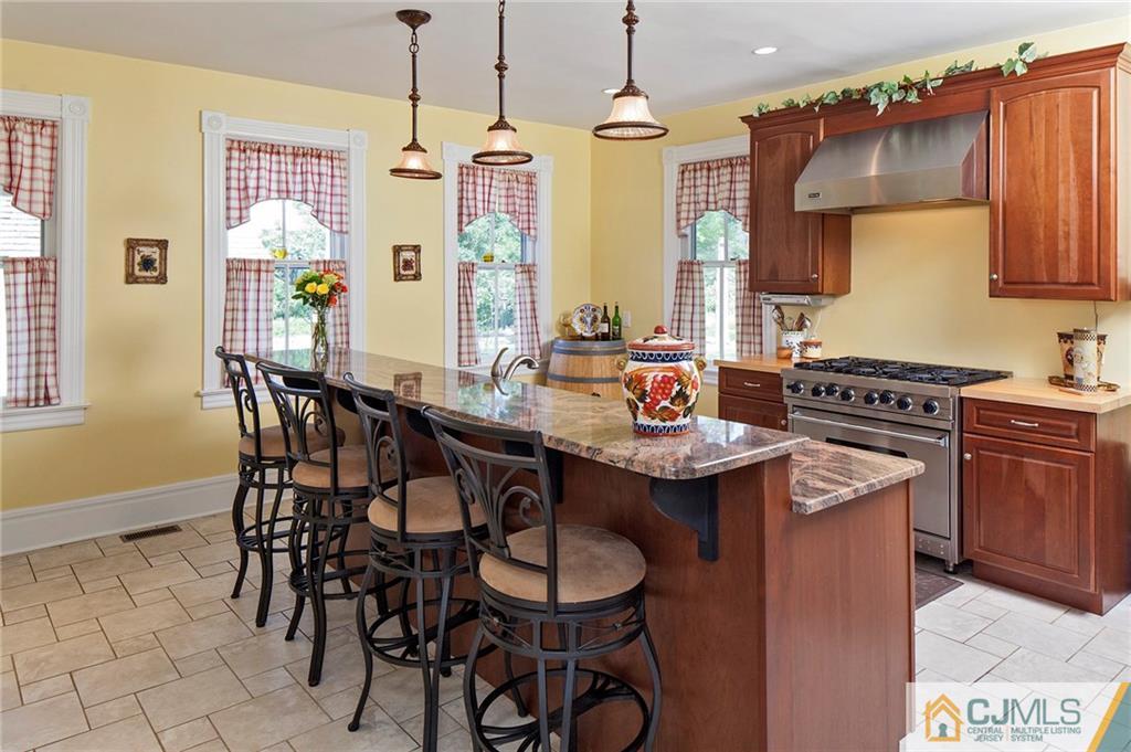 136 Mapleton Road Princeton, NJ 08540 - Photo 10 of 25 a kitchen with stainless steel appliances granite countertop a sink a stove and chairs