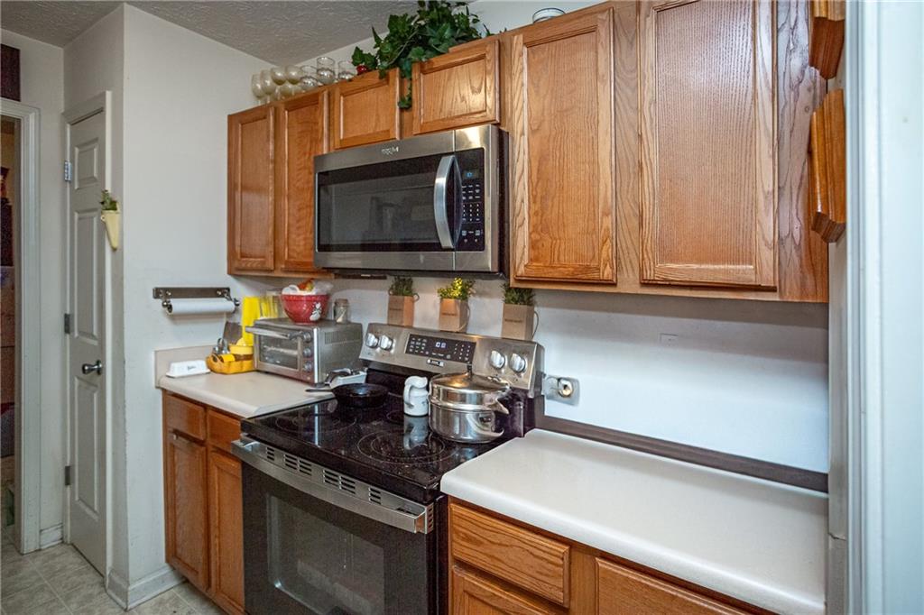 194 Cemetery Road Luthersville, GA 30251 - Photo 11 of 19 a kitchen with a sink stove and microwave