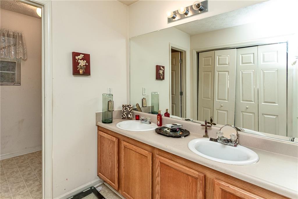 194 Cemetery Road Luthersville, GA 30251 - Photo 14 of 19 a bathroom with a double vanity sink and a mirror