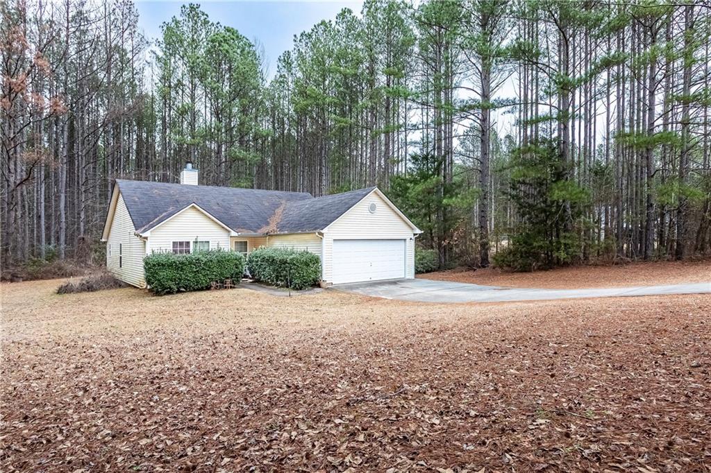 194 Cemetery Road Luthersville, GA 30251 - Photo 2 of 19 a view of a house with a yard and pathway