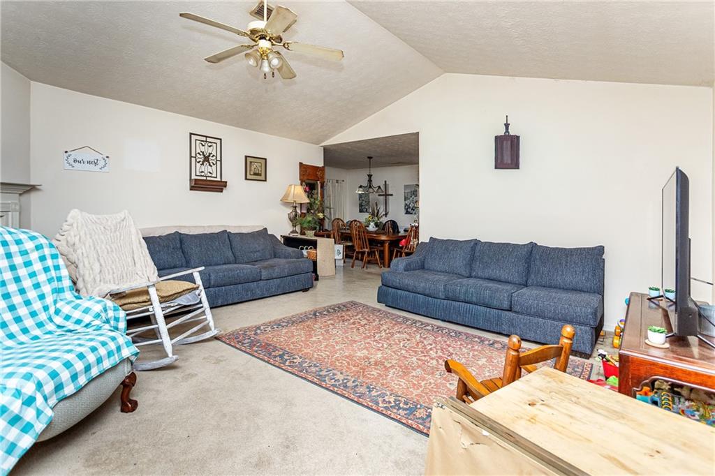 194 Cemetery Road Luthersville, GA 30251 - Photo 4 of 19 a living room with furniture and a chandelier