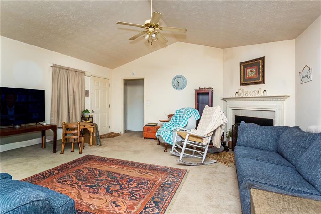 194 Cemetery Road Luthersville, GA 30251 - Photo 6 of 19 a living room with furniture and a flat screen tv