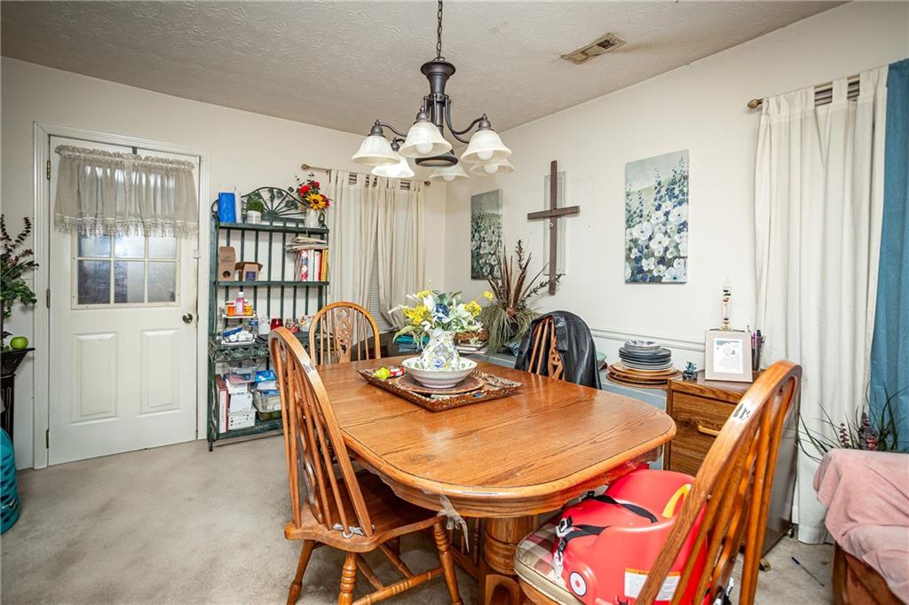 194 Cemetery Road Luthersville, GA 30251 - Photo 7 of 19 a dining room with furniture a chandelier and window
