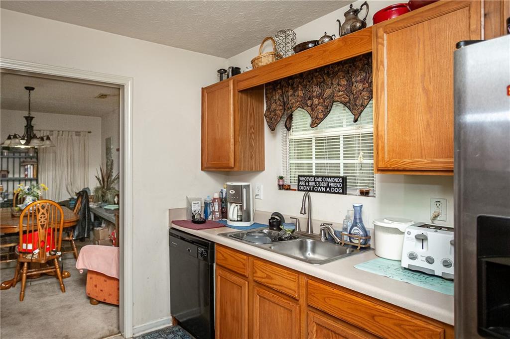 194 Cemetery Road Luthersville, GA 30251 - Photo 9 of 19 a kitchen with stainless steel appliances sink cabinets and window