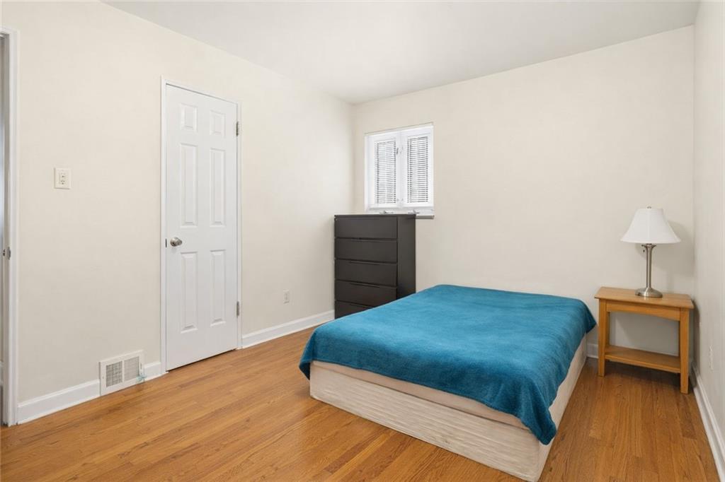 2129 Admiral Street Aliquippa, PA 15001 - Photo 20 of 34 a bedroom with a bed and wooden floor