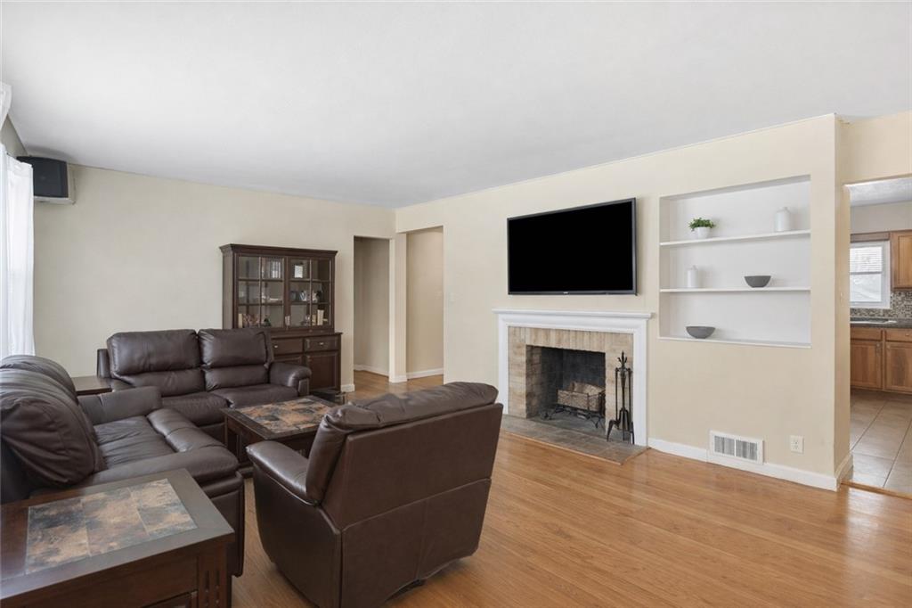 2129 Admiral Street Aliquippa, PA 15001 - Photo 3 of 34 a living room with furniture a fireplace and a flat screen tv