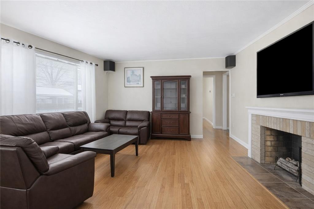 2129 Admiral Street Aliquippa, PA 15001 - Photo 5 of 34 a living room with furniture a flat screen tv and a fireplace