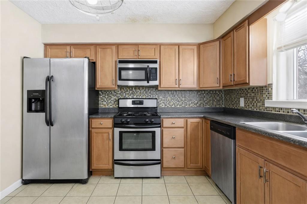 2129 Admiral Street Aliquippa, PA 15001 - Photo 10 of 34 a kitchen with stainless steel appliances granite countertop a refrigerator stove and sink