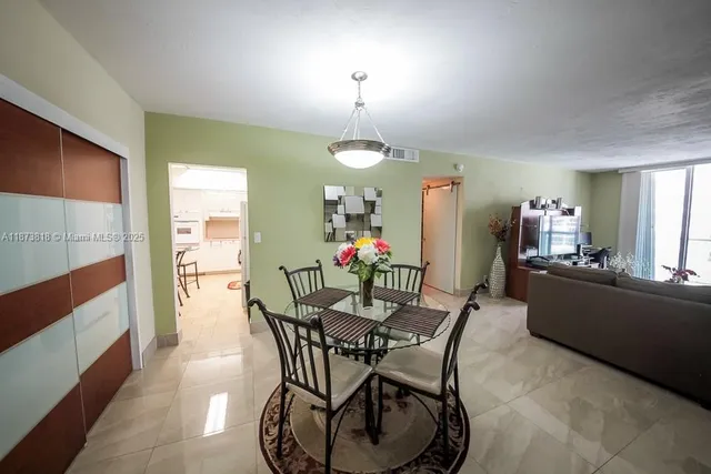 a kitchen with refrigerator and cabinets