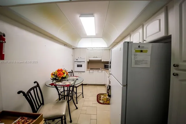 a kitchen with a sink appliances and cabinets