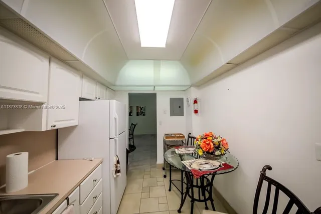 a bathroom with a granite countertop shower sink vanity and toilet