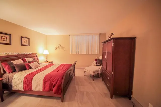 a bedroom with a bed and a lamp with the wall painting