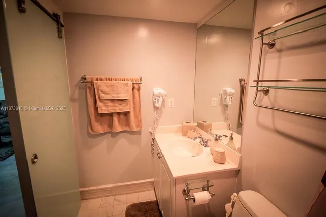 a hallway with a large mirror and a dresser