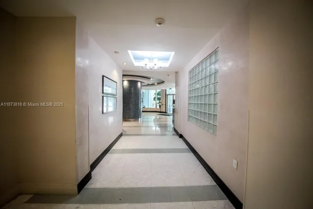 a living room with furniture potted plant and a chandelier