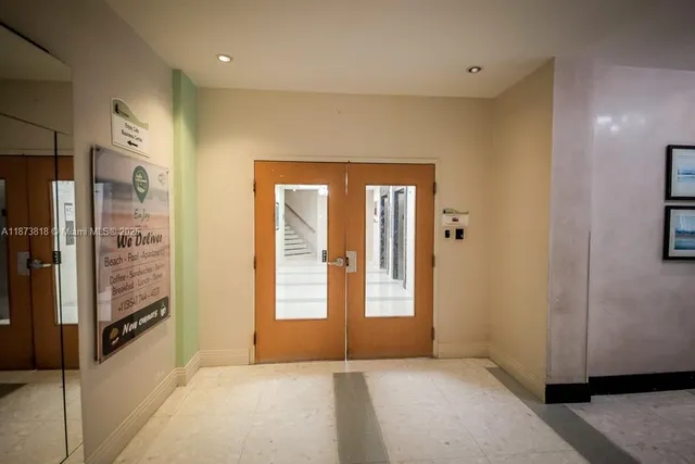 a living room with furniture a chandelier and a large window