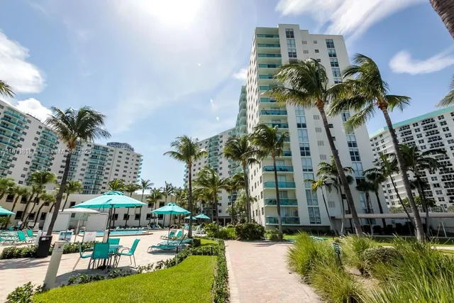 a swimming pool with outdoor seating and a garden