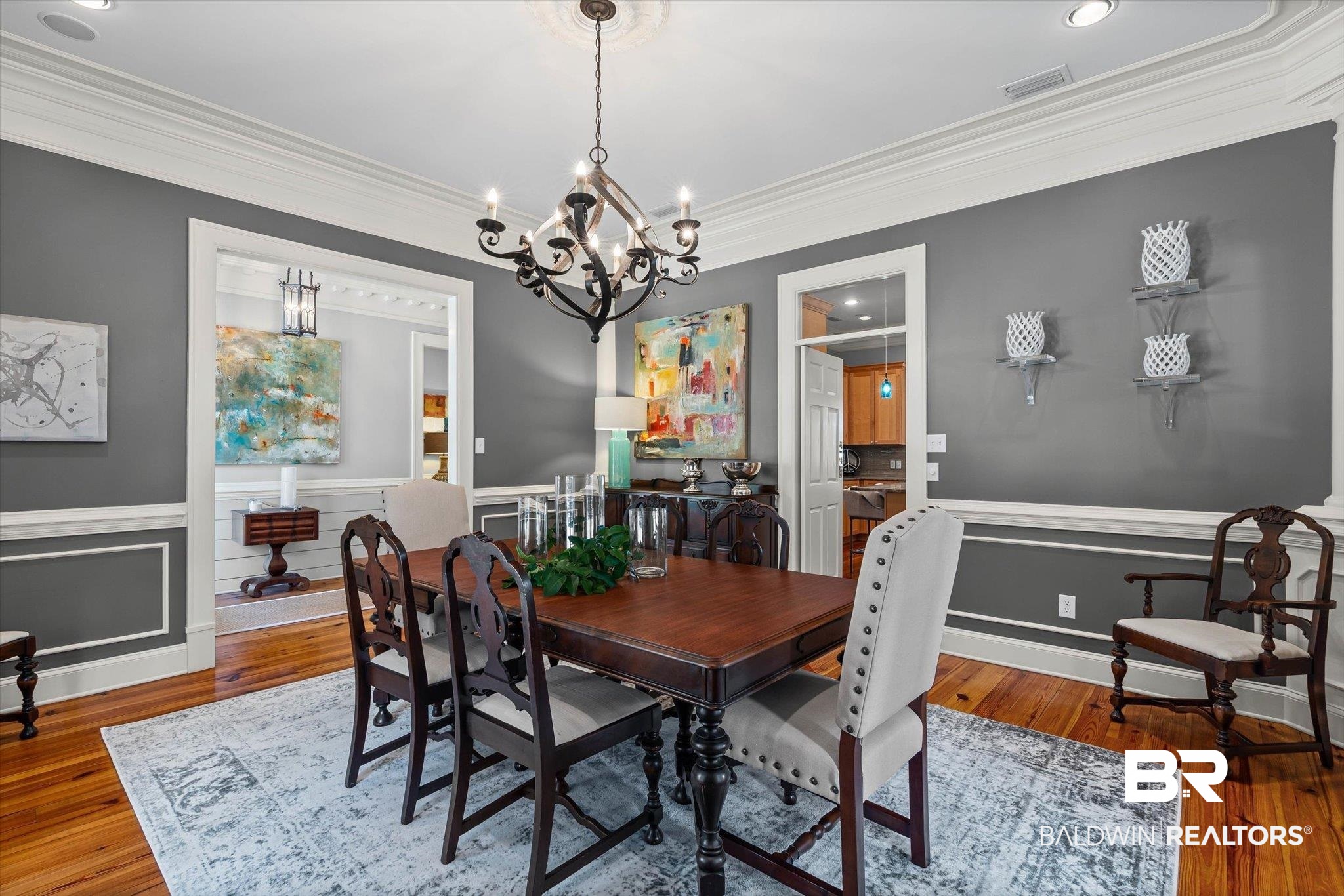 7015 Bay Road Mobile, AL 36605 - Photo 6 of 53 Dining room featuring hardwood / wood-style flooring, wainscoting, ornamental molding, a chandelier, and a decorative wall