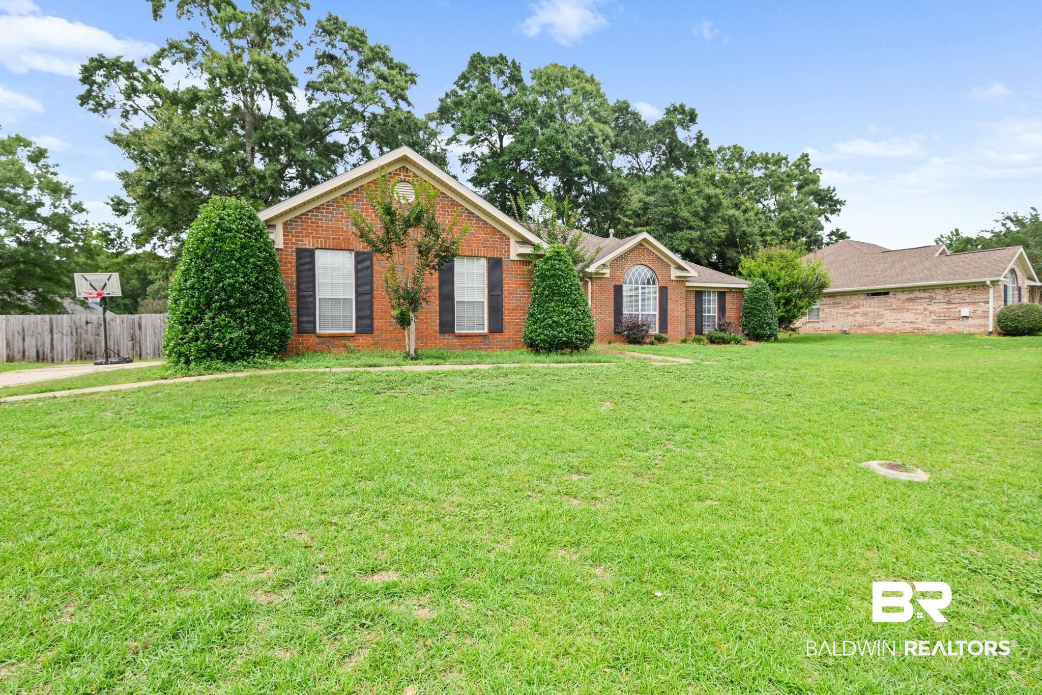 9422 Labrador Run South Mobile, AL 36695 - Photo 2 of 36 Brick exterior residence with a prominent arched window and dark shutters