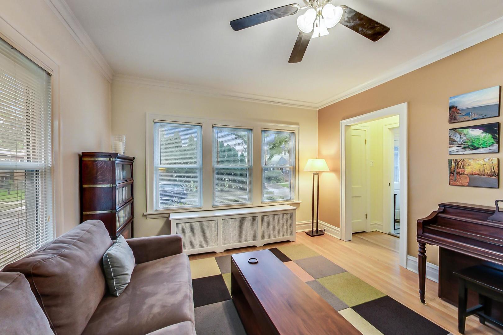 205 East Quincy Street Riverside, IL 60546 - Photo 8 of 46 a living room with furniture and a large window