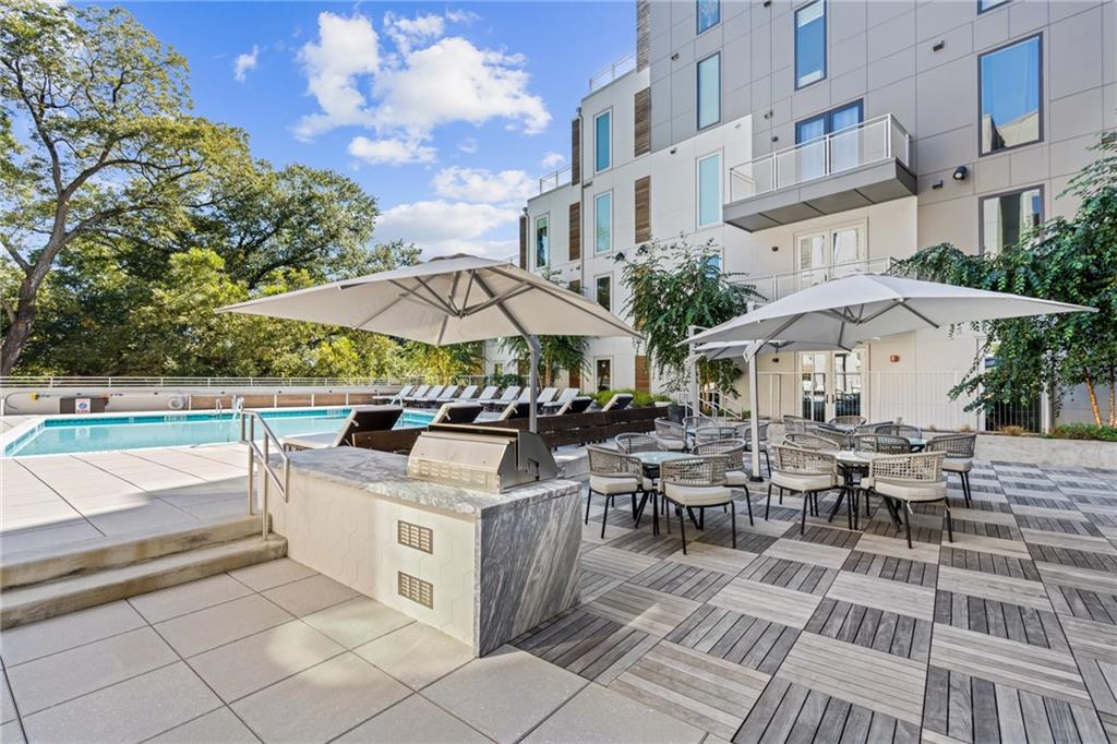 775 Juniper Street Northeast, Unit 227 Atlanta, GA 30308 - Photo 20 of 42 a view of a patio with chairs and tables