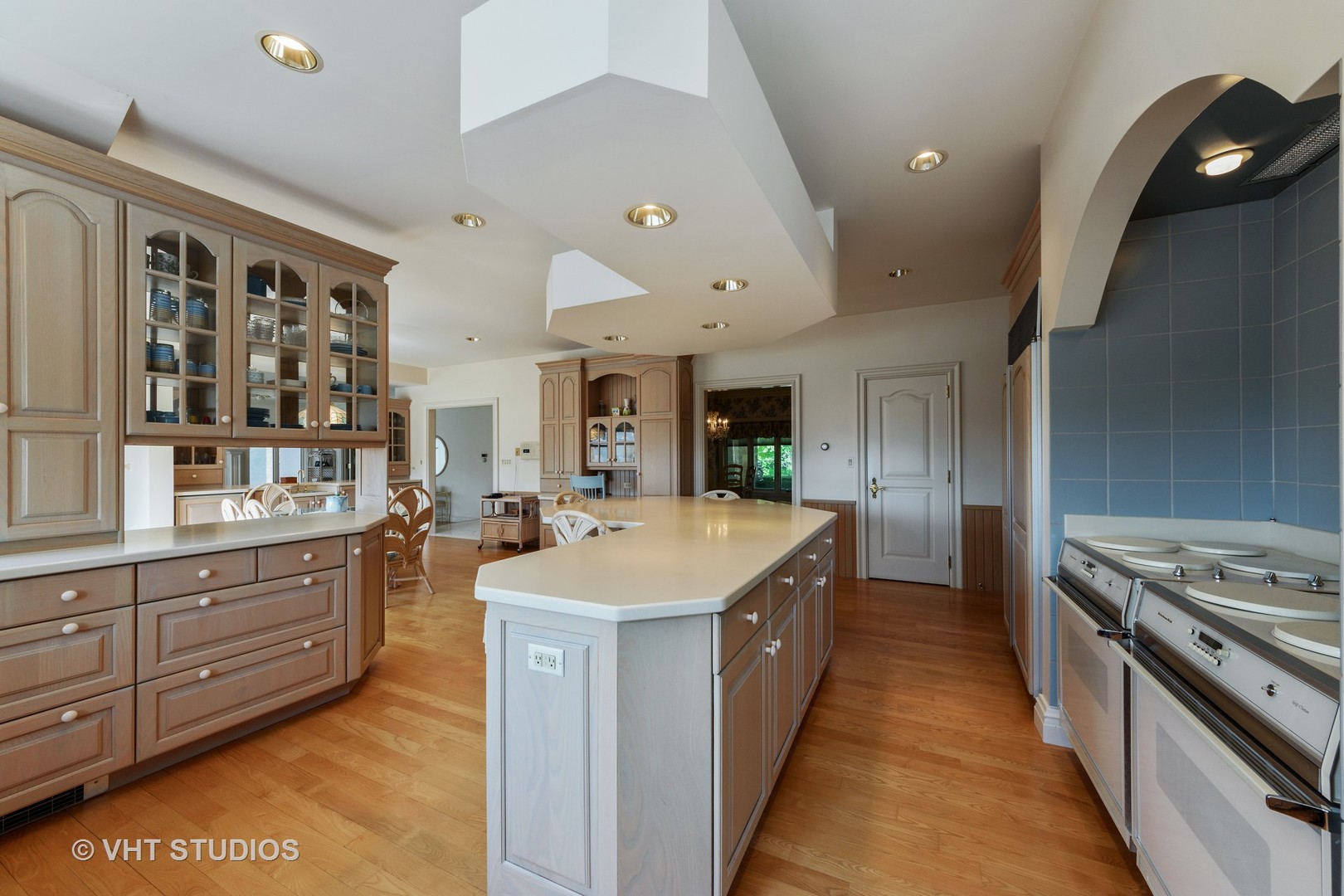 215 West Dundee Road Barrington, IL 60010 - Photo 7 of 34 a large kitchen with stainless steel appliances a stove a sink dishwasher and cabinets with wooden floor