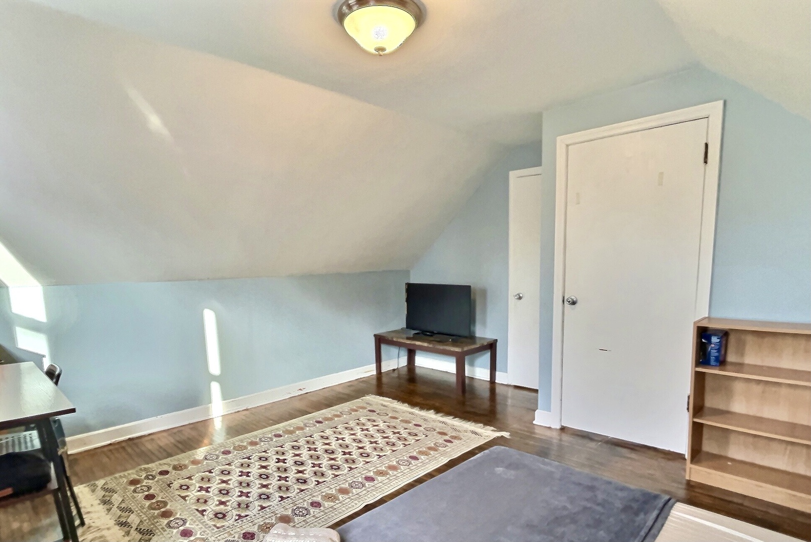 712 South 4th Street DeKalb, IL 60115 - Photo 11 of 25 a view of a bedroom with wooden floor and bathroom