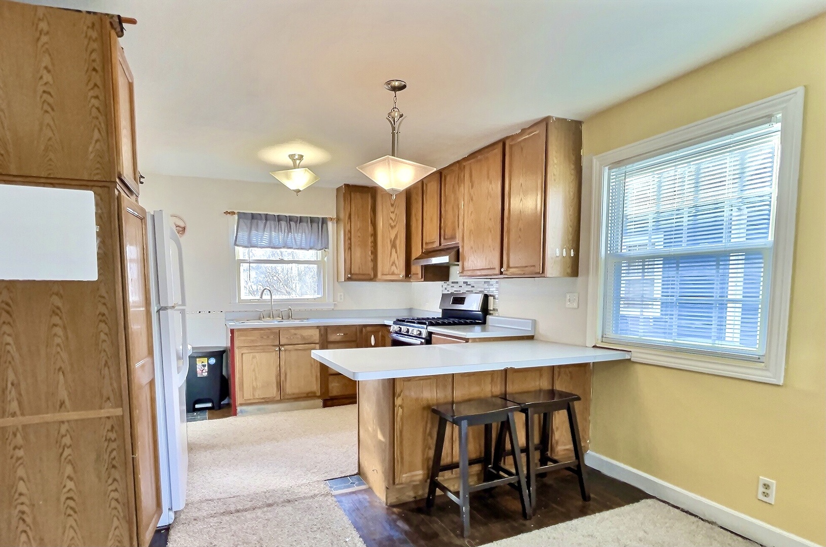 712 South 4th Street DeKalb, IL 60115 - Photo 3 of 25 a kitchen with a sink cabinets and window