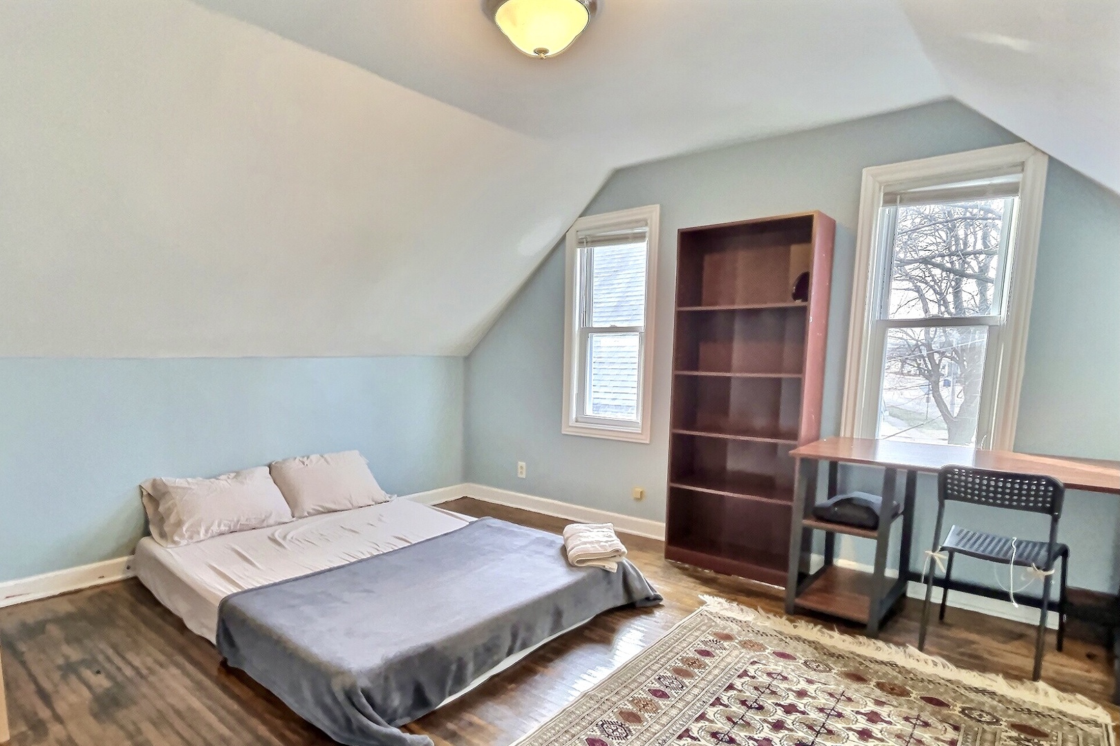 712 South 4th Street DeKalb, IL 60115 - Photo 10 of 25 a bedroom with a bed dresser and a window