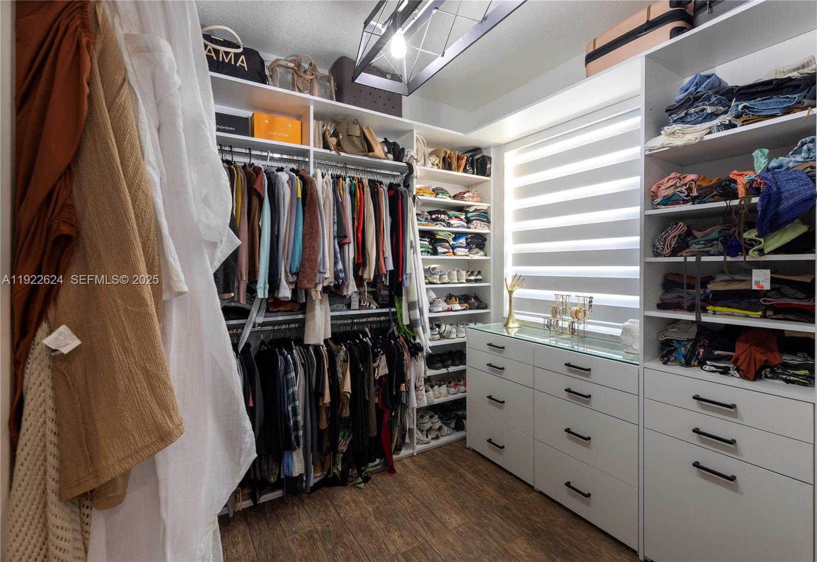 13276 Southwest 128th Street Miami, FL 33186 - Photo 26 of 27 a view of walk in closet with clothes and shoes