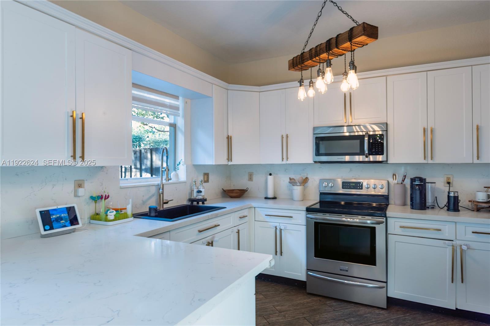13276 Southwest 128th Street Miami, FL 33186 - Photo 6 of 27 a kitchen with stainless steel appliances granite countertop a sink a stove top oven a counter space and cabinets