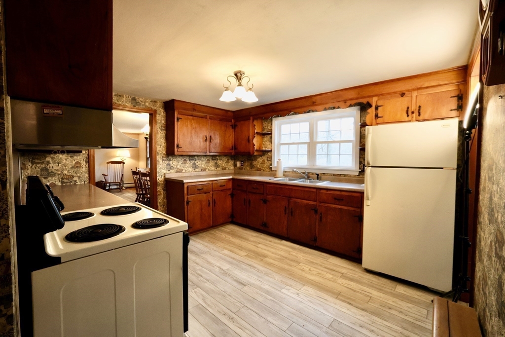 93 Ferry Road Salisbury, MA 01952 - Photo 6 of 32 a kitchen with a refrigerator a stove a sink and a microwave