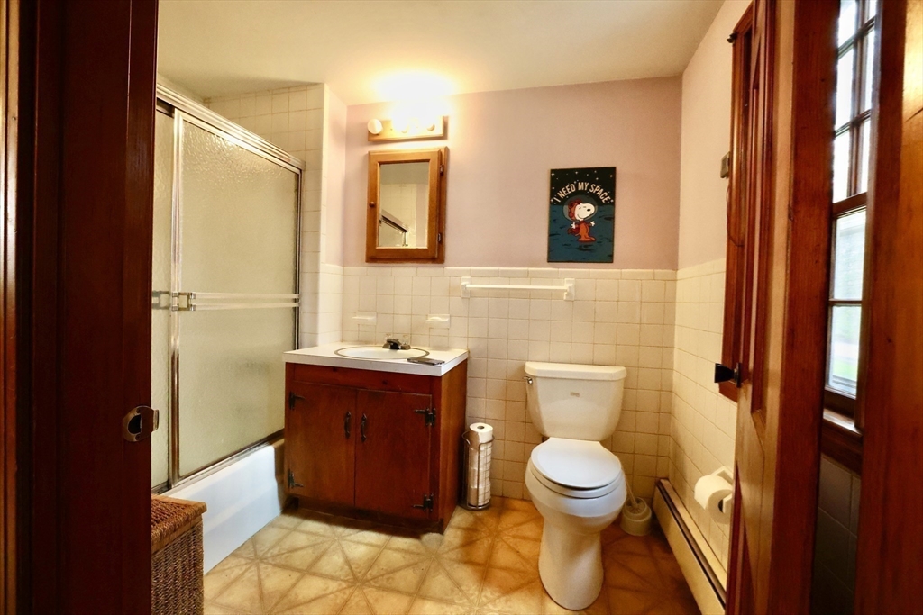 93 Ferry Road Salisbury, MA 01952 - Photo 7 of 32 a bathroom with a toilet sink and mirror