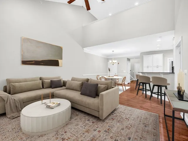 a living room with furniture and a dining table