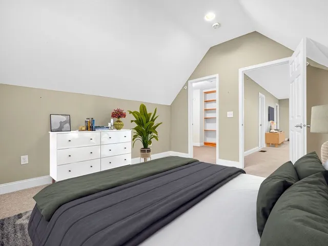 a bedroom with a bed and a dresser