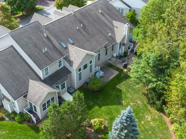 an aerial view of a house with a yard