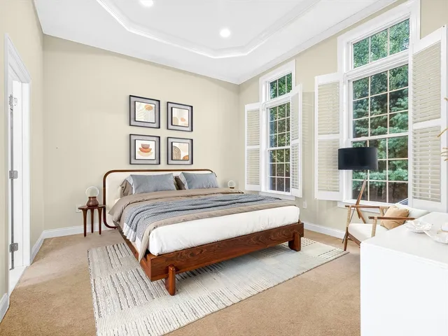 a spacious bedroom with a bed and a large window